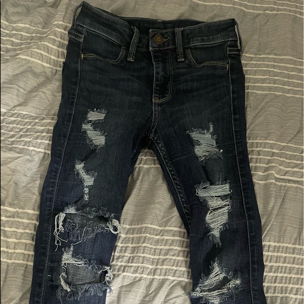 stretchy skinny jeans from Hollister. Dark blue with a lot of rips. lightly worn